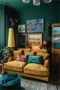 a living room filled with furniture and pictures on the wall