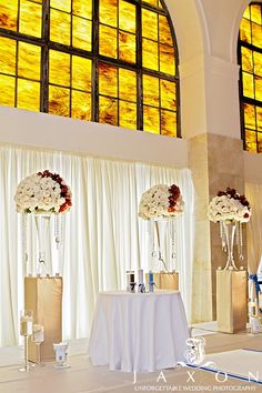 an elegant wedding setup in front of stained glass windows