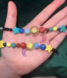 Planets bracelets that are out of this world! Made with homemade beads from polymer clay Bracelets can be customized by length, metal type, star color, and the style of the planets' rings. Bracelet length comes in XS (5.5 in), Sm (6 in), Med (6.5 in), Lg (7 in), and XL (7.5 in) They can be made with either white, yellow, or blue large stars The planets' rings can be either simple or braided The lobster clasp, chain, and small stars come in silver or gold and are both tarnish resistant. Please ch Unique Adjustable Resin Bracelets, Homemade Beads, Space Bracelet, Polymer Clay Bracelets, Planet Bracelet, Bracelet Clay, Planet Ring, Clay Bracelets, Small Stars