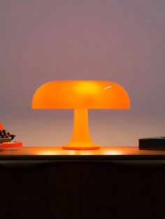 a table lamp sitting on top of a wooden desk