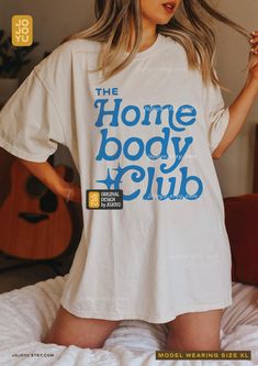 "The Homebody Club" Unisex T-shirt Design by jojoyu This item is made to order. If you want an oversized fit please size up! for reference, the model on the photo is usually a medium but wearing XL for an oversized fit. About the shirt: ◦ color: ivory ◦ relaxed fit  ◦ soft-washed, garment-dyed fabric ◦ double-needle stitching throughout the tee makes it highly durable  ◦ made with medium fabric (6.1 oz/yd²) consisting of high quality, 100% ring-spun US cotton for long-lasting comfort ◦ made with 100% US cotton that is ethically grown and harvested Copyright ©2024 Jojoyu. All rights reserved. Homebody Club, Homebody Shirt, Cute Lounge, Music Merch, Home Cozy, Retro Funny, Music Life, Capsule Outfits, Retro Humor