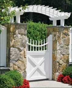 a white gate with an arch over it