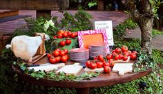 a table topped with lots of different types of tomatoes and cheese on top of it