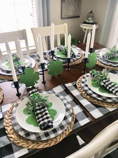 a dining room table set for st patrick's day with plates and napkins