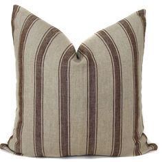 a brown and white striped pillow on a white background