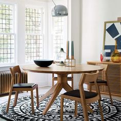 a dining room table with chairs and a bowl on it