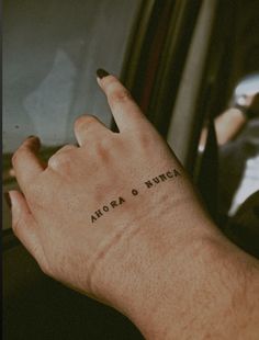 a person's hand with the word aurora and numeral written on it