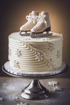 a cake with white frosting and ice skates on top