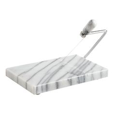 a marble cutting board with a knife sticking out of it