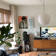 a living room filled with furniture and a flat screen tv sitting on top of a wooden table