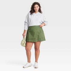 Elevate your collection of bottoms for casual occasions with this Wrap Miniskirt from Universal Thread™. Crafted from midweight cotton fabric in a regular fit, this wrap miniskirt offers a perfect balance of comfort and style. It's designed with a side button closure for a snug fit, while the flap and cargo pockets provide space for small essentials. Pair it with just about any top in your closet for a number of versatile looks. Universal Thread™: Found exclusively at Target. Spring Relaxed Fit Skort With Pockets, Casual Cotton Tennis Skirt For Spring, Cotton Tennis Skirt, Cotton Skirted Shorts With Lined Skirt, Casual Green Cotton Cargo Skirt, Green Cotton Skort With Pockets, Cotton Skirted Skort With Lined Skirt, Casual Cotton Lined Mini Skirt, Casual Cotton Mini Tennis Skirt