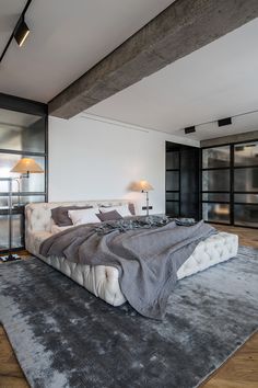 a large bed sitting on top of a wooden floor