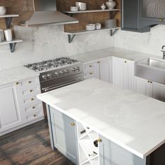 a kitchen with white counter tops and gray cupboards next to a stove top oven