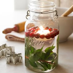 a jar filled with water and candles on top of a table