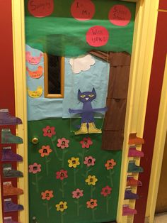 a classroom door decorated with flowers and a cat