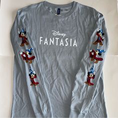 New H&M Disney Fantasia Long Sleeve T-Shirt. Round Neck. Mickey Mouse On Sleeves. Size M. 092823/489 Long Sleeve Character Print T-shirt For Disney Trips, Disney Cotton Shirt For Disney Fan Events, Disney Long Sleeve Top With Cartoon Print, Disney Cotton Shirt, Disney-themed Cotton Shirt, Disney Mickey Mouse Fan Merchandise Tops, Disney Long Sleeve Top With Graphic Print, Fun Mickey Mouse Tops For Disney Trips, Long Sleeve T-shirt With Character Print For Disney Events