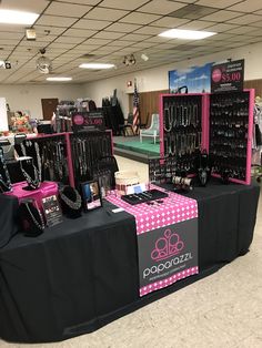 there are many jewelry on display in the store and one is black with pink polka dots