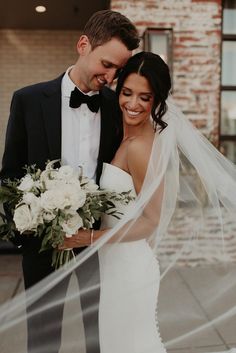 a bride and groom pose for a wedding photo