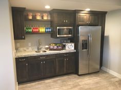 a kitchen with stainless steel appliances and wooden cabinets