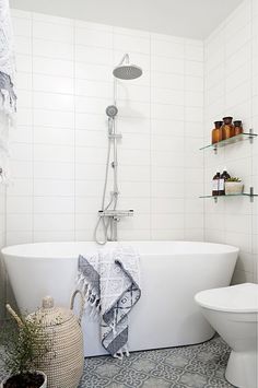 a white bath tub sitting next to a toilet