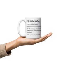 a person's hand holding a coffee mug with the words church user printed on it