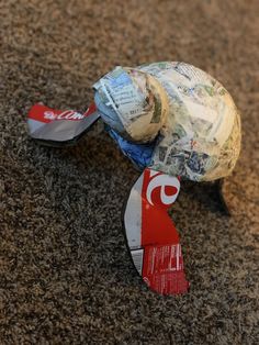 a ball and some newspaper on the ground