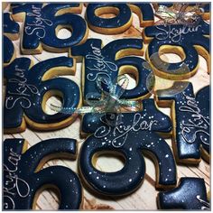 decorated birthday cookies with the number sixty six in blue and gold frosting on a wooden table