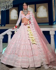 Reverie Bridal set is a stunning coral pink lehenga hand embroidered on pure raw silk fabric with signature glass crystals, pearls, sequins, and beads and has scalloped edges on the lehenga. It's paired with an attractive hand-embroidered blouse with cap sleeves on net fabric. It comes with a peachy pink soft net scall Pastel Lehenga, Latest Bridal Lehenga, Raw Silk Lehenga, Lehenga Designs Simple, Raw Silk Fabric, Traditional Indian Dress, Green Lehenga, Indian Party Wear, Pastel Dress