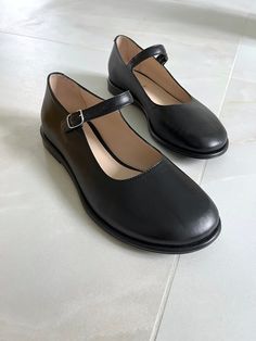 "An undying classic - Mary Jane flats  - in a modern Italian shoe form! A sneak peek into our spring collection :) This pair with an almond toe is handcrafted from smooth black Italian leather with leather lining. A wide toe and arch strap will add a layer of comfort. These women's flats are a \"not boring\" masterpiece that perfectly complements any look. Memory insoles along the entire length of the shoe, are soft and remember the position of the foot. Tunit sole is a mixture of leather chips and rubber, it's more wear-resistant than leather and more durable. Also, we use soft natural upper materials that wear well and take the shape of the foot. In the photos:  STYLE name: JUL MATERIALS: black leather, silver or golden buckle COLOR: Black  PERSONALIZATION: I can offer you a custom-made Luxury Closed Toe Mary Jane Flats, Classic Mary Janes With Almond Toe Medium Width, Classic Medium Width Mary Janes With Almond Toe, Classic Mary Janes With Almond Toe, Classic Mary Janes With Leather Sole And Almond Toe, Classic Mary Janes With Leather Sole, Classic Mary Janes With Removable Insole And Almond Toe, Classic Mary Janes With Almond Toe And Removable Insole, Classic Low Heel Mary Janes With Rubber Sole