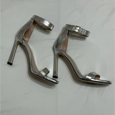 Condition: Used, Only Used Twice. Brand: Stuart Weitzman Width: Medium Features: Sandal, Stiletto Heel, Rounded Square-Toe, Adjustable Ankle Strap, Crafted By Sw Artisans In Spain. Materials: Liquid Metallic Leather, Leather Insole, Leather Outsole. Made In Spain Fitted Open Heel Dinner Heels, Fitted Heels With Heel Strap For Dinner, Dinner Heels With 4-inch Heel, Elegant Heels With Single Toe Strap For Date Night, 4-inch Heel Fitted Heels For Dinner, Fitted 4-inch Heel Dinner Heels, Fitted 4-inch Heel For Dinner, Chic Silver Heels With Single Toe Strap, Leather Ankle Strap Heels For Dinner