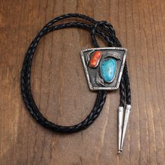 Vintage sterling silver turquoise and coral bolo tie. There is no artist's hallmark on this piece. The bolo features a 7/8" long by 3/8" wide coral stone and a 1 1/4" long by 3/4" wide turquoise stone. Three silver leaves and stampwork complete the design. The bolo face measures  2 3/16" tall by 2 1/4" wide. The cord and tips measure 45" long. The tips are guaranteed to be sterling silver. The bolo tie is in good condition. Thank you for shopping in our store. Please let us know if you have ques Silver Leaves, Bolo Ties, Turquoise And Coral, Coral Stone, Bolo Tie, Tie Accessories, Jewelry Inspo, Silver Leaf, Silver Turquoise