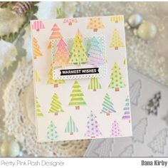 a close up of a card with christmas trees on it and the words warm wishes