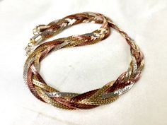 "Vintage 80s braided tricolore triple chevron flat snake chain necklace with the sensuous shiny polished looks of the pale gold, silver and copper (dark rose gold) and the decorative texture and understated elegance. The necklace is 1 cm (0.4\") wide,44 cm (17.3\") long  including the spring ring clasp,weighs 40 gr and in excellent vintage condition. For more vintage jewellery please visit my Etsy shop: http://vintageviomar.etsy.com SHIPPING  UK -Royal Mail 1st Class (delivery aim 1- 2 days)  Everywhere Else - Royal Mail International Tracked and Signed  (delivery aim 10-14 days) INTERNATIONAL BUYERS-PLEASE NOTE: Import duties,taxes and charges are not included in the item price or shipping cost.These charges are buyers responsibility.Please check with your country's custom office to deter Snake Chain Necklace Gold, Decorative Texture, Chain Necklace Gold, Snake Chain Necklace, Dark Rose, Statement Choker Necklace, Custom Office, Pale Gold, Understated Elegance