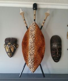 some african masks are hanging on the wall