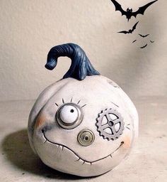 a white pumpkin with a face painted on it