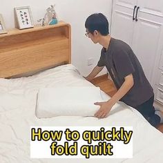 a man laying on top of a white bed next to a wooden headboard with the words how to quickly fold quilt