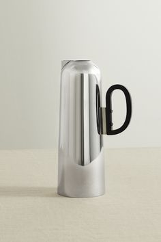 a stainless steel coffee pot with black handles