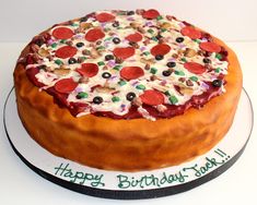 a birthday cake with pepperoni, olives, and other toppings on it