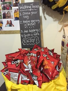 a pile of chips sitting on top of a table next to a chalkboard sign