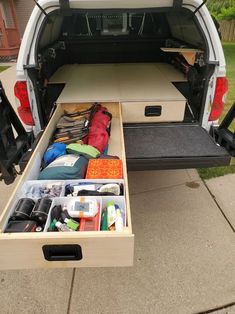 an open trunk in the back of a white van