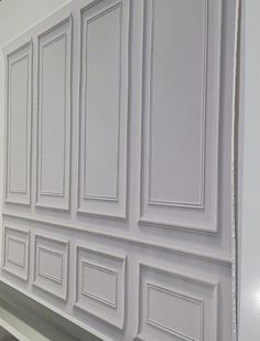 the white cabinets are lined up against the wall