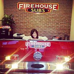 a woman sitting in the back of a fire truck