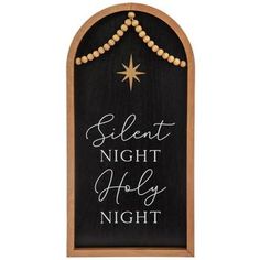 Dimensions: 23.5" H x 11.5" W x 0.85" D Material: MDF & Jute Shape: Arch Top Color: Black, Brown, White & Gold Orientation: Vertical Includes: 1 Sawtooth Hanger Quantity: 1 Lend a sentimental highlight to your holiday decor with this Silent Night Holy Night Wood Wall Decor. This arch-shaped piece boasts a wood grain frame around a black base. Decorating the base is a gold star and the lyrics "Silent Night Holy Night." Hanging from the arch are two beaded strands of jute, adding an element of rustic charm to the piece. Hang it in the entryway or the living room to enhance your home decor with a reminder of the reason for the season! Silent Night Door Hanger, O Night Divine Sign, Manger Door Hanger Nativity Scenes, O Holy Night Sign, Silent Night Holy Night, Wall Decor Hobby Lobby, Holy Night, Silent Night, Christmas Wall Art