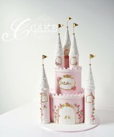 the cake is decorated with pink and gold princess castle designs on it's sides