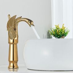 a gold faucet sitting on top of a white counter