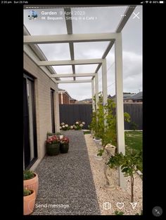 an outdoor patio with potted plants and gravel