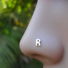 "✨ Luxurious Elegance: Minimalist Initial Sterling Silver Nose Ring ✨ 🌟 Transform Your Style: A Touch of Radiance! Discover the quintessence of beauty and elegance with our nose stud designs, meticulously crafted for the modern woman. Made with the finest 925 sterling silver, this nose silver ring is more than just jewelry; it's a statement of your unique style and grace. 🔹 Why You'll Love Your New Silver Nose Ring: 👑Luxurious 925 Sterling Silver Quality Gentle on Your Skin: We understand the Cute Nose Rings, Stud Nose Ring, Cute Nose, Rings Cute, Sterling Silver Nose Rings, Ear Lobe Piercings, Earring Cartilage, Ruby Earrings Studs, Tragus Earring