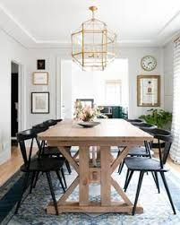 the dining room table is surrounded by black chairs