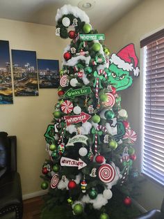 a christmas tree decorated with street signs and candy canes