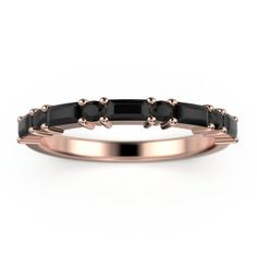 a rose gold ring with black stones